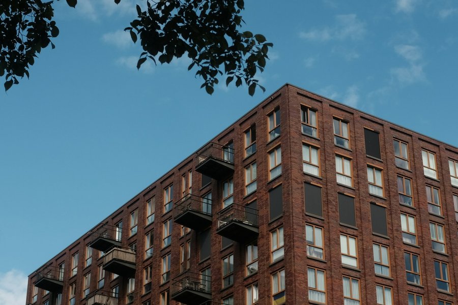Edifício residencial moderno com varandas, sob céu azul